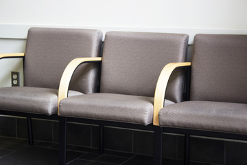 Close up of row of empty chairs in office waiting room