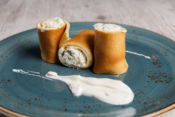 European pancakes, crepes, with cream cheese and sour cream