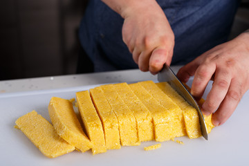 Chef cutting polenta