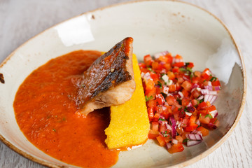 Salted fish soup with polenta and vegetable salad