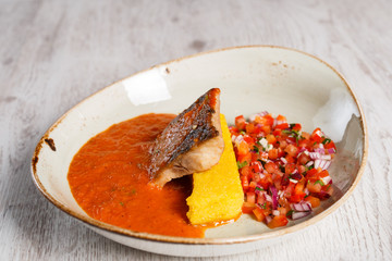 Salted fish soup with polenta and vegetable salad
