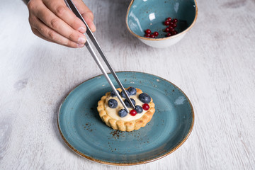 Chef decorating a forest fruit tart