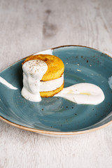 Polenta with cheese topped with sour cream