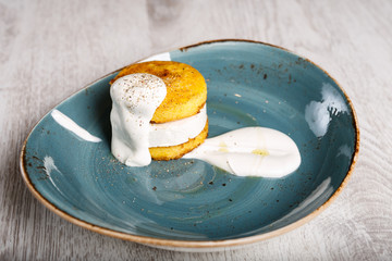 Polenta with cheese topped with sour cream