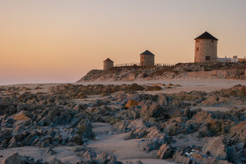 Old traditional wind-mills in sand-hills of Apulia Portugal.