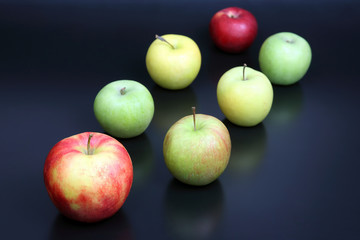 fresh different apples on dark background