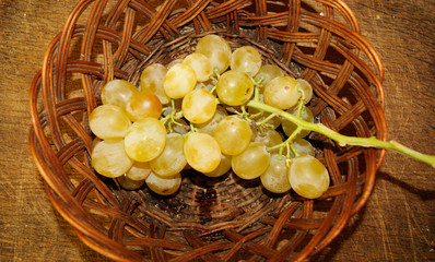 Bunch of yellow grapes in a little basket