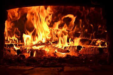 hot flaming wood in the hearth close-up-background image