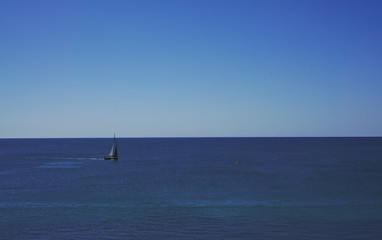 Sailing boat on blue sea