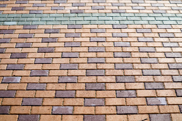 Naklejka premium pattern of brick wall on paving floor near playground in park