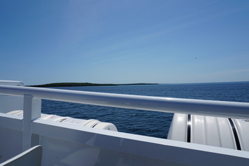 View from side of boat with lake and horizon in background