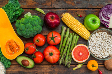 Fresh organic fruit and vegetables, white beans, oatmeal, and blackberries. Concept of cooking and eating healthy food, fitness, dieting, vegetarian food, vegan cuisine and healthy lifestyle. 