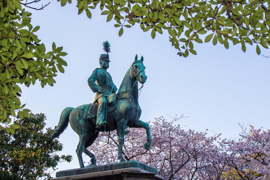 Ueno Sakura Matsuri at Ueno Park(Ueno Koen),Taito,Tokyo,Japan on April 7,2017:Bronze statue of Prince Komatsu Akihito (Komatsu-no-miya Akihito shinno) and cherry blossoms in the background