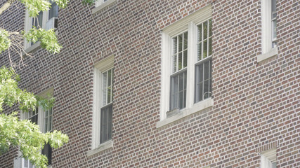 Naklejka premium Typical exterior establishing photo outside brick apartment building in city. Brooklyn style setting day time DX