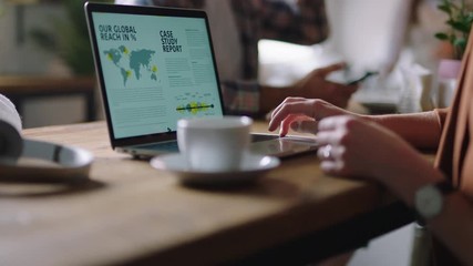 close up hands caucasian business woman using laptop computer in cafe reading document online drinking coffee browsing brainstorming enjoying busy restaurant