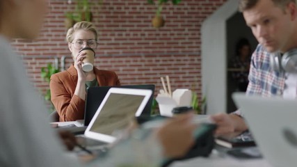 group of engineers developing facial recognition software technology using digital tablet computer brainstorming design solution sharing project ideas in busy office meeting - Powered by Adobe