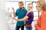 Young office workers discussing