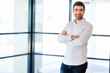 Young caucasian businessman standing in office