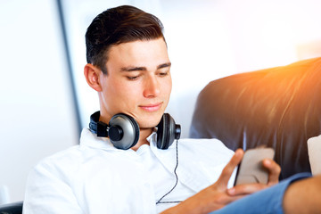 Portrait of young man holding phone