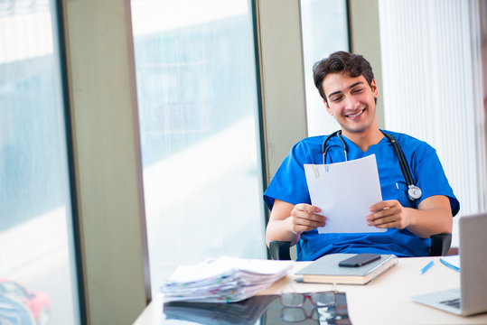 Young handsome doctor working in the hospital 