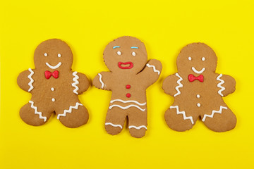 Christmas cookies, gingerbread In the form of a man on yellow background. Christmas background