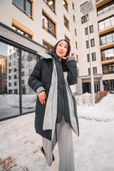 fashion outdoor photo of gorgeous sensual woman with black hair in elegant clothes  walking by winter city