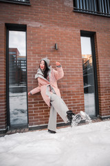 fashion outdoor photo of gorgeous sensual woman with black hair in elegant clothes  walking by winter city