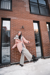 fashion outdoor photo of gorgeous sensual woman with black hair in elegant clothes  walking by winter city