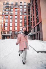 fashion outdoor photo of gorgeous sensual woman with black hair in elegant clothes  walking by winter city