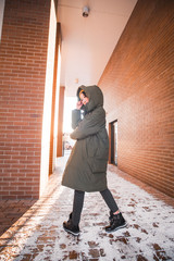 fashion outdoor photo of gorgeous sensual woman with black hair in elegant clothes  walking by winter city