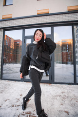 fashion outdoor photo of gorgeous sensual woman with black hair in elegant clothes  walking by winter city