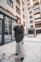 fashion outdoor photo of gorgeous sensual woman with black hair in elegant clothes  walking by winter city
