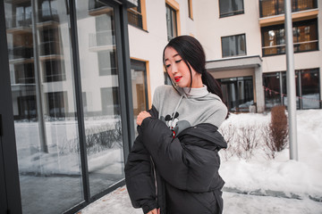 Obraz premium fashion outdoor photo of gorgeous sensual woman with black hair in elegant clothes walking by winter city