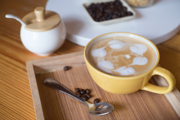 Hot coffee in cups, sugar and cakes
