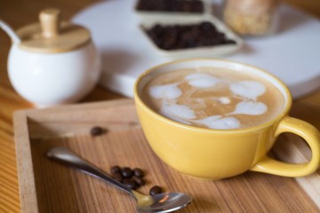 Hot coffee in cups, sugar and cakes