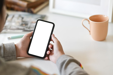 Close-up shot of female hands holding touch mobile phone with isolated screen