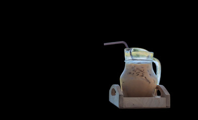 Iced coffee in a glass jar on  black background.