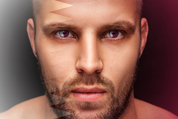 Obraz premium Portrait of a young serious man, in whose eyes the reflected national flag of Qatar, against an isolated black background and flag