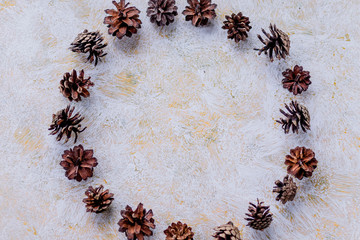round of brown fir cones on a white background on New Year's Eve. Christmas advent calendar.Pine cones for decoration at modern house. Interior concept.Christmas wreath concept.Copy space