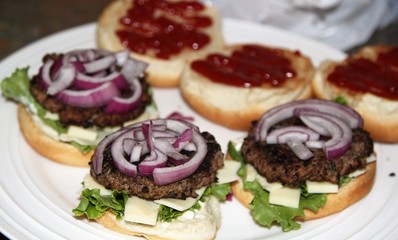 Hamburgers with red onion slices