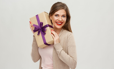 Happy girl holding gift. Isolated portrait
