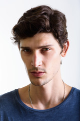 Fototapeta premium Face of young handsome Brazilian man looking at camera