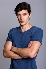 Obraz premium Studio shot of young handsome man with arms crossed