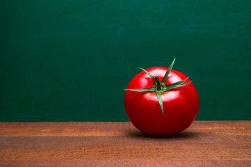 Whole Red Tomato On A Wooden Table. Green Background. Organic Food. Cooking Ingredients. Pomodoro...