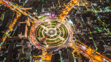 Aerial view road roundabout with car lots, road traffic in city at night.