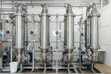 Production of milk and yogurt at the plant. Metal units and tanks for storage and transportation.