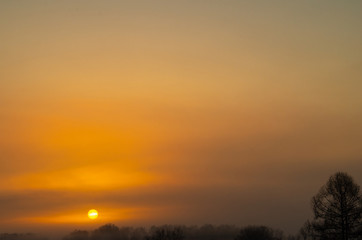 Fototapeta na wymiar Mystical sunrise over the misty forest