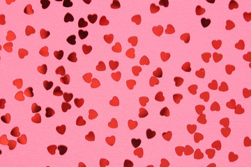 Pink background with red confetti hearts for Valentine Day