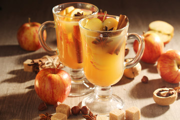 Two cups with hot cider in cold season with cinnamon and anise