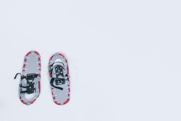 a pair of snowshoes, on white-fluffy snow, with a place for the inscription